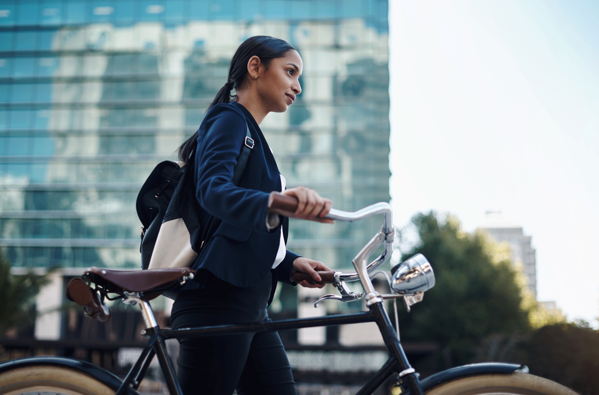 Student commuting to work by bike in a modern city environment